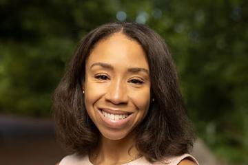 Candice Powell smiling while looking straight ahead