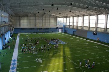 Aerial view of the band rehearsing on a Carolina practice field.