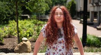 Blue Sky Scholar Zoey Ainsworth poses for an outdoor portrait.
