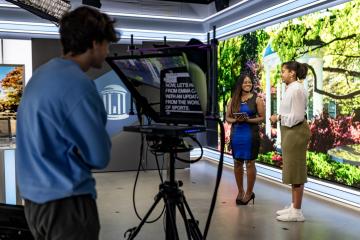 Students record segment in a broadcast studio