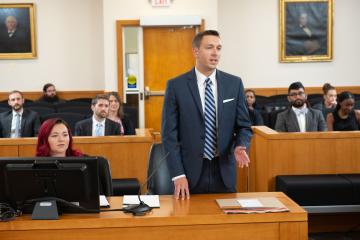 Person stands in a court of law and presents an argument