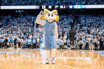 Rameses mascot on the basketball court at a game