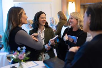 4 Carolina volunteers talk to each other at an event