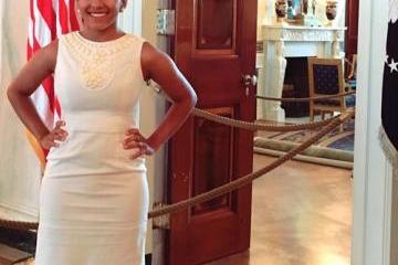 Andrea Barnes smiles for a photo in a doorway. 