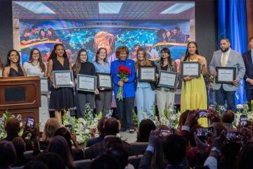 Deloris P. Jordan on stage with Jordan Family Scholars