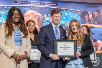 Dean Denby-Brinson, Chancellor Roberts, and Sydney Hines on stage.