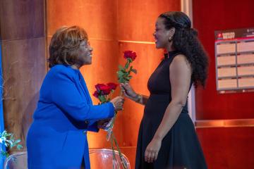 Doris P. Jordan hands a rose to Tali Bowe.