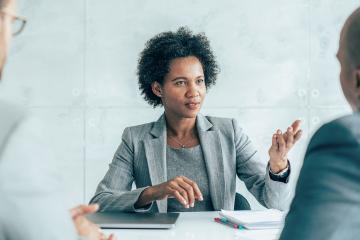 A woman negotiates in a conference room.