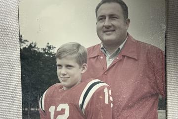 Thad Eure Jr. and Thad Eure III posing for a youth football photo