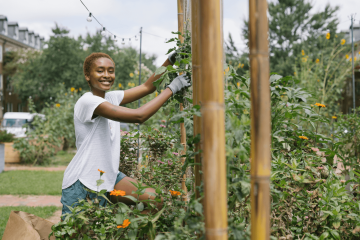 Raegan Murphy smiling and working in a garden.