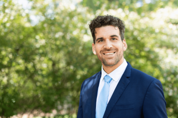 Frank Leibfarth smiling in front of an outdoor background.