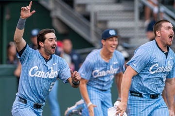 UNC baseball players run onto field and cheer