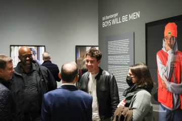 People convene in front of an art exhibit.