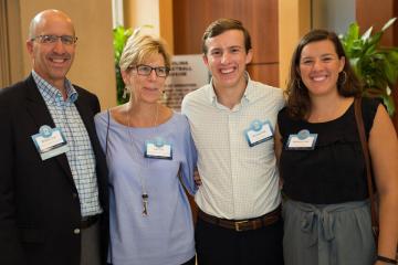 Carolina parents pose with their 2 children at a CPLS event