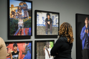 Person observes an exhibit up close.