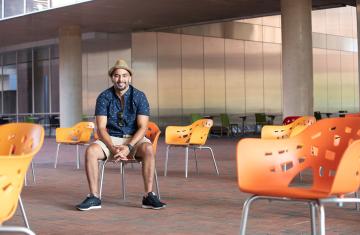Esteban Agudo sitting in front of building.