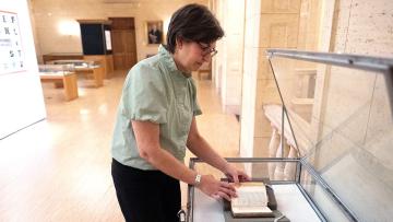 Eileen Dewitya turns pages in The Odyssey