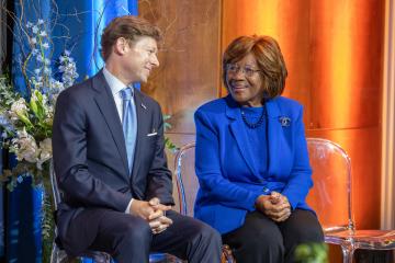 Chancellor Roberts and Deloris P. Jordan sit on a stage.