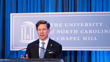 Chancellor Lee H. Roberts speaking at a podium at an event welcoming him as Carolina's 13th chancellor on Aug. 9, 2024, at Kenan Center. (Jon Gardiner/UNC-Chapel Hill)
