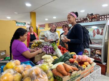 UNC-Chapel Hill students and faculty participate in a field study project focused on nutrition while standing in a grocery store.