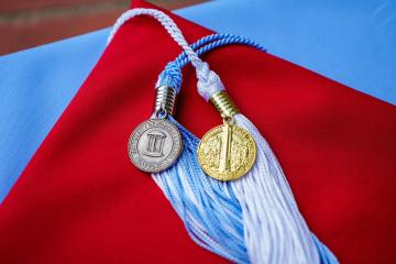 UNC-Chapel Hill and NC State University graduation caps laying one on top of the other 
