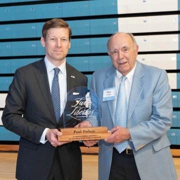 Chancellor Lee Roberts holding the 2025 Lux Libertas Philanthropy Award to Paul Fulton &rsquo;57