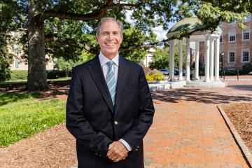 John Preyer standing in front of the Old Well with South Building in the background