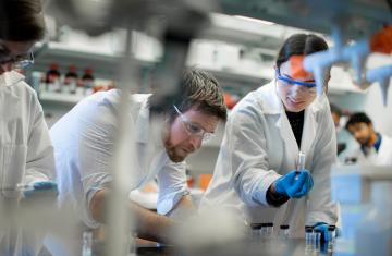 Owen Fenton and a member of his team conduct research in the Fenton Lab