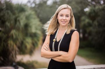 Kristy Woodson Harvey poses with arms crossed.