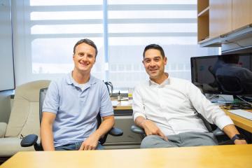 Andrew Satterlee and Shawn Hingtgen sitting behind a desk and facing the viewer