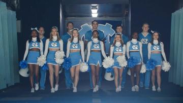 Carolina cheerleaders marching out of a tunnel at Kenan Stadium.