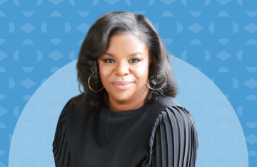 Portrait of Professor Blair Kelley on a Carolina blue background