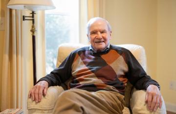 Dr. Frederick Bowman sits in a lounge chair at his home in Chapel Hill