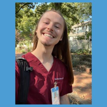 Blackburn takes a selfie while walking down the street in scrubs.