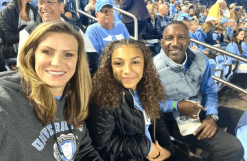 Brandy Barnes (left), her daughter Summer Barnes '27 and husband Chris Barnes at a Carolina Football game.