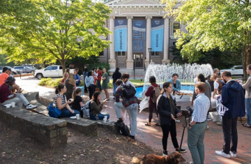 Students gather around the water fountain in front of Bynum Hall