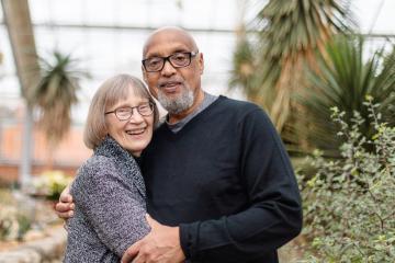 The Hodges couple in a greenhouse.