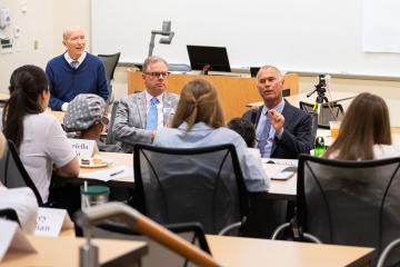 Dr. Gerard Bell and Dr. Richard Workman seated in front of students in a Bell Leadership Institute course.