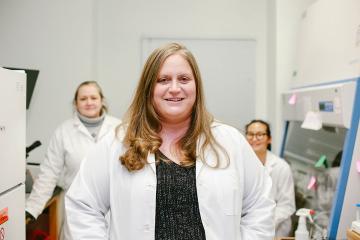 Erin Heinzen faces the camera in her lab