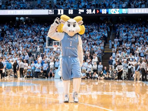 Rameses mascot on the basketball court at a game