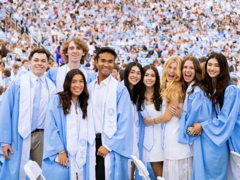 Students pose for a picture at Carolina's 2025 commencement in Kenan Stadium