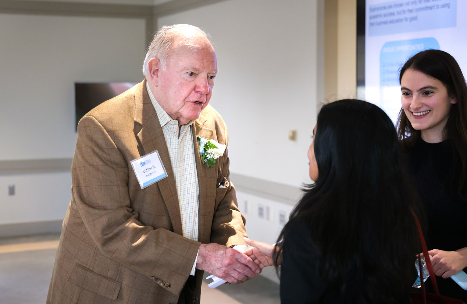 Carolina donor Luther Hodges greets recipients of a scholarship created in his name